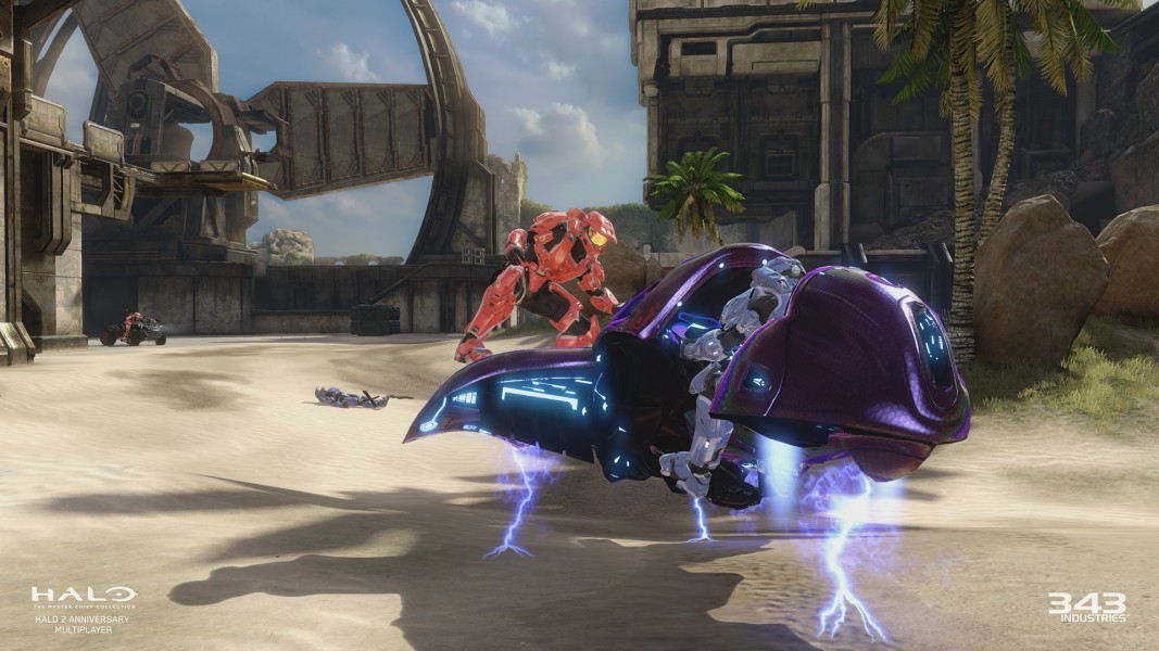 Halo 2 Multiplayer - In-game screenshot from the multiplayer for Halo 2. A player from the Red Team is about to hijack a Ghost from another player from the Blue Team.