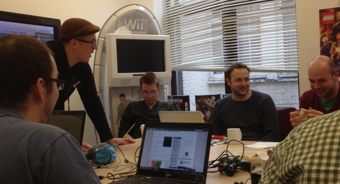 Journalists and student game developers huddled around.